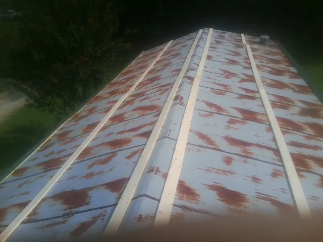 Rusted metal roof panels with new wood purlins before replacement — Storm Damage Roof Repair in Keedysville by Roofing Brothers