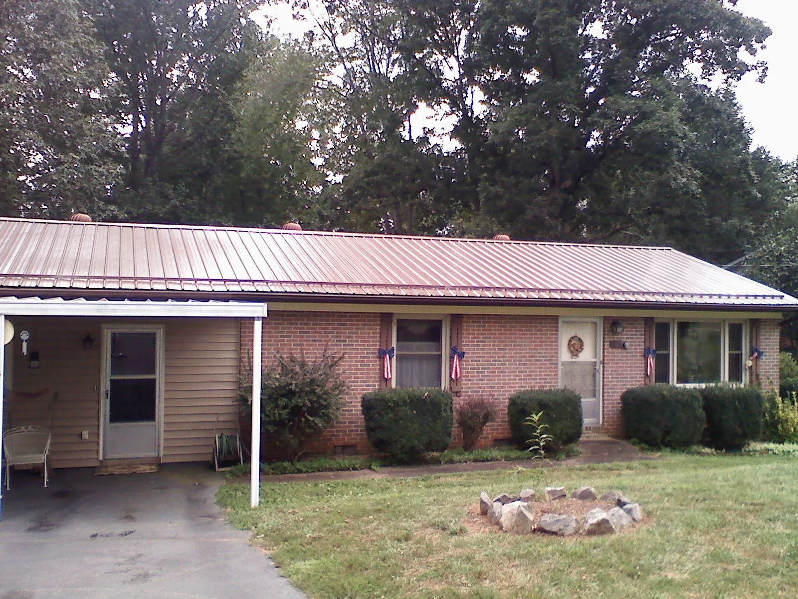 Bronze metal roof and carport on a brick ranch home — Roof Repair work by our crew in Keedysville